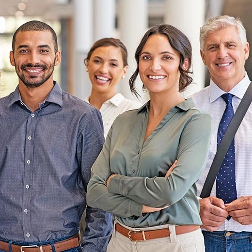 A group of smiling people dressed in business casual clothes